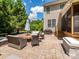 Outdoor patio has a grill and seating area great for entertaining, with lawn and trees in background at 10944 Persimmon Creek Dr, Mint Hill, NC 28227