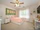 Cozy bedroom features natural light, a ceiling fan, and a calming atmosphere perfect for rest and relaxation at 10944 Persimmon Creek Dr, Mint Hill, NC 28227