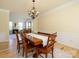Bright and open dining room, with hardwood floors and a view into the adjacent living area at 10944 Persimmon Creek Dr, Mint Hill, NC 28227