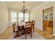 Traditional dining room with a wooden table and chairs set beneath an elegant chandelier at 10944 Persimmon Creek Dr, Mint Hill, NC 28227