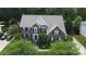 Stately brick home with manicured landscaping, shutters, large windows, and an inviting entryway, offering classic curb appeal at 10944 Persimmon Creek Dr, Mint Hill, NC 28227