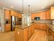 Open kitchen with granite countertops, island, stainless steel appliances and wood floors at 10944 Persimmon Creek Dr, Mint Hill, NC 28227
