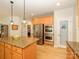 Bright open kitchen with granite countertops, pantry, stainless steel appliances, and hardwood floors at 10944 Persimmon Creek Dr, Mint Hill, NC 28227