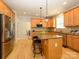 Spacious kitchen with granite countertops, island, stainless steel appliances and hardwood floors at 10944 Persimmon Creek Dr, Mint Hill, NC 28227