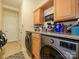 Well-equipped laundry room with front loading washer/dryer and granite countertops at 10944 Persimmon Creek Dr, Mint Hill, NC 28227