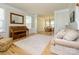 An inviting living room with a piano, hardwood floors, and a view into the dining room at 10944 Persimmon Creek Dr, Mint Hill, NC 28227