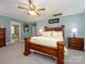 Spacious main bedroom boasts a large bed, ceiling fan, and serene atmosphere with soft, natural light and calming colors at 10944 Persimmon Creek Dr, Mint Hill, NC 28227