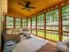 Relaxing screened porch with a ceiling fan, comfortable seating, and a view of the backyard at 10944 Persimmon Creek Dr, Mint Hill, NC 28227
