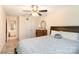 Bright bedroom features a ceiling fan, dresser, closet, and ensuite bathroom at 11329 Corliss Ave, Charlotte, NC 28277