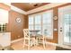 Charming breakfast nook with wooden table, bright windows and door leading to the exterior at 11329 Corliss Ave, Charlotte, NC 28277