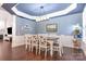Dining room with hardwood floors, wainscoting, and modern lighting at 11329 Corliss Ave, Charlotte, NC 28277