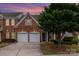 Brick home, complemented by a mature tree, under a colorful sky at 11329 Corliss Ave, Charlotte, NC 28277