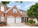 Charming brick home with two-car garage, manicured landscaping, and a welcoming front porch at 11329 Corliss Ave, Charlotte, NC 28277