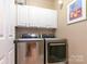 Well-equipped laundry room with modern appliances and ample cabinet space at 11329 Corliss Ave, Charlotte, NC 28277