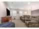 Living room with an entertainment center, television, leather furniture, and natural lighting at 11329 Corliss Ave, Charlotte, NC 28277