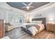 Relaxing main bedroom boasts tray ceilings, hardwood floors, and bright shutters at 11329 Corliss Ave, Charlotte, NC 28277