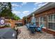 Brick patio with outdoor dining set, grill, hot tub and privacy fence at 11329 Corliss Ave, Charlotte, NC 28277