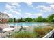 Large community swimming pool with surrounding chairs and tables at 11329 Corliss Ave, Charlotte, NC 28277