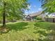 Large backyard featuring a lush lawn, mature trees, wooden fence, and a charming patio with a fountain at 11727 Dunham Dr, Matthews, NC 28105