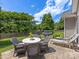 Backyard with patio, grill, lounge chairs, and green lawn at 11727 Dunham Dr, Matthews, NC 28105