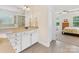 Bright bathroom featuring white cabinets, granite counters, and tile floors with views into the main bedroom at 11727 Dunham Dr, Matthews, NC 28105
