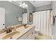 Bathroom features a double sink vanity, large mirror, shower with curtain, and toilet at 11727 Dunham Dr, Matthews, NC 28105