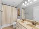Bathroom featuring double sink vanity and shower with curtain at 11727 Dunham Dr, Matthews, NC 28105