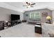 Bonus room with TV, futon, ottomans, and vaulted ceilings at 11727 Dunham Dr, Matthews, NC 28105