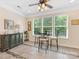 Bright breakfast nook with tiled floors, modern furniture, and natural light streaming through three large windows at 11727 Dunham Dr, Matthews, NC 28105