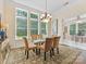 Bright dining room with large windows, elegant chandelier, and stylish furnishings at 11727 Dunham Dr, Matthews, NC 28105