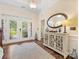 Elegant foyer with hardwood floors, decorative cabinet, and lots of natural light at 11727 Dunham Dr, Matthews, NC 28105