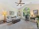 Comfortable home office with ample natural light, neutral decor, and a relaxing couch for breaks at 11727 Dunham Dr, Matthews, NC 28105