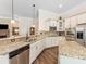 Bright kitchen features granite countertops, stainless appliances, and wood flooring at 11727 Dunham Dr, Matthews, NC 28105