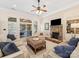 Comfortable living room with a stone fireplace, large windows, and sliding glass doors to the patio at 11727 Dunham Dr, Matthews, NC 28105