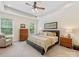 Serene main bedroom with trey ceiling, plush carpeting, and a view of the backyard at 11727 Dunham Dr, Matthews, NC 28105