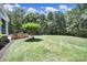 Well-maintained backyard with ample green space, a built-in grill station, and lush landscaping at 128 Spears Creek Dr, Mooresville, NC 28117