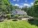 Expansive backyard featuring a patio, fire pit, and a charming home exterior at 128 Spears Creek Dr, Mooresville, NC 28117