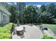 An entertainer's backyard patio features a built-in grill, stone fire pit, and outdoor dining area at 128 Spears Creek Dr, Mooresville, NC 28117