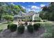 Expansive backyard with lush greenery, patio, and screened-in porch at 128 Spears Creek Dr, Mooresville, NC 28117