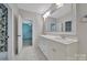 Bright bathroom featuring marble floors, double vanity and a large framed mirror for an elegant feel at 128 Spears Creek Dr, Mooresville, NC 28117