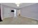 Spacious bedroom with attached bathroom, plush carpet, natural light and a warm, inviting ambiance at 128 Spears Creek Dr, Mooresville, NC 28117