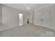 Bright bedroom featuring neutral walls, plush carpet, and access to the en-suite bathroom and closet at 128 Spears Creek Dr, Mooresville, NC 28117