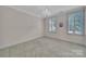 Bedroom featuring a chandelier, neutral walls, plush carpet, and natural light creates a serene retreat at 128 Spears Creek Dr, Mooresville, NC 28117
