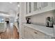Butler's pantry featuring custom cabinetry, marble countertops, and modern appliances for added convenience at 128 Spears Creek Dr, Mooresville, NC 28117