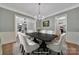 This dining room boasts hardwood floors, a contemporary chandelier, and is perfect for entertaining guests at 128 Spears Creek Dr, Mooresville, NC 28117