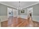 Open-concept dining area with hardwood floors, elegant lighting, and easy access to other rooms at 128 Spears Creek Dr, Mooresville, NC 28117