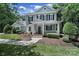 Charming two-story home featuring a welcoming front porch and beautifully landscaped front yard at 128 Spears Creek Dr, Mooresville, NC 28117
