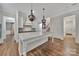 Bright kitchen featuring a large island with marble countertop and stylish pendant lights at 128 Spears Creek Dr, Mooresville, NC 28117