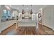 Open kitchen layout with a large island, modern appliances, and hardwood floors at 128 Spears Creek Dr, Mooresville, NC 28117