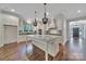 Spacious kitchen with white cabinets, large island, and modern lighting fixtures at 128 Spears Creek Dr, Mooresville, NC 28117